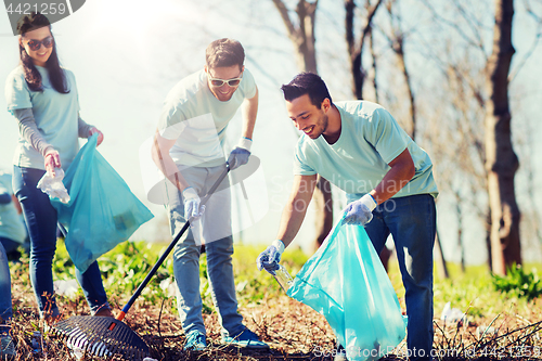 Image of volunteers with garbage bags cleaning park area