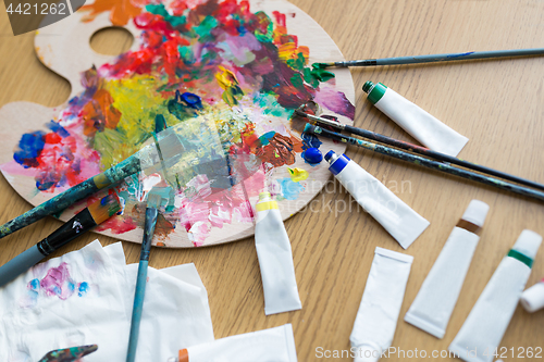 Image of palette, brushes and paint tubes on table
