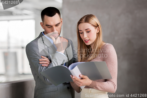 Image of businesswoman and businessman with folder