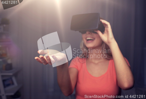 Image of happy woman in virtual reality headset or glasses 