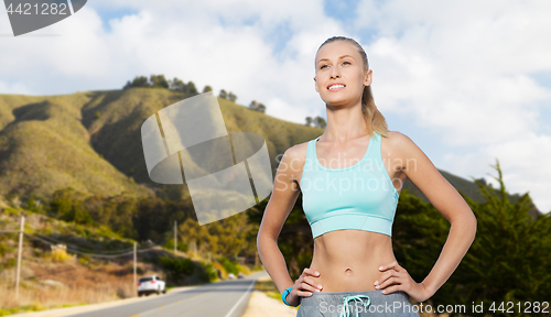 Image of happy young woman doing sports outdoors