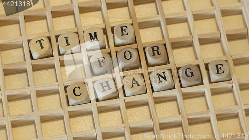 Image of wooden dice time for change