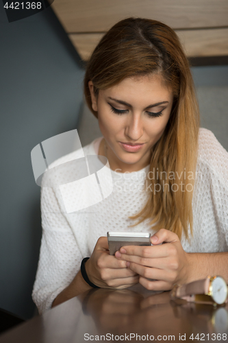 Image of young woman using mobile phone