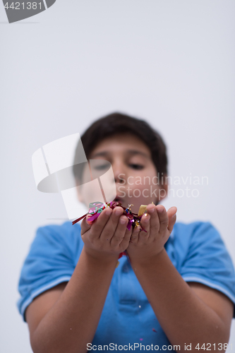 Image of kid blowing confetti