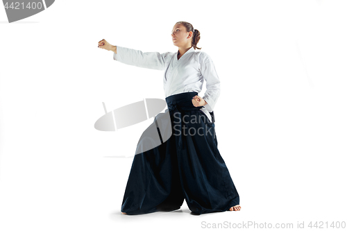 Image of Aikido master practices defense posture. Healthy lifestyle and sports concept. Woman in white kimono on white background.