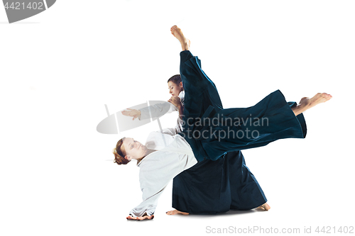 Image of Man and woman fighting at Aikido training in martial arts school