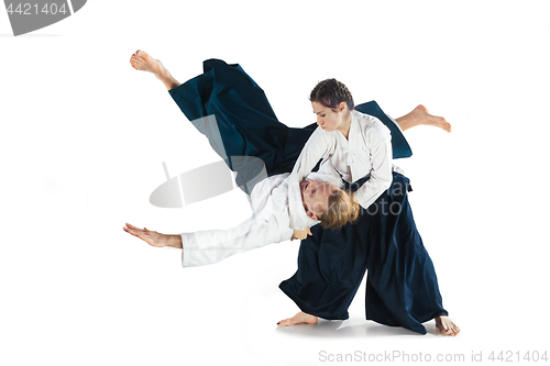 Image of Man and woman fighting at Aikido training in martial arts school