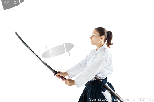 Image of Aikido master practices defense posture. Healthy lifestyle and sports concept. Woman in white kimono on white background.