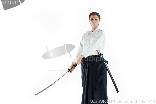 Image of Aikido master practices defense posture. Healthy lifestyle and sports concept. Woman in white kimono on white background.