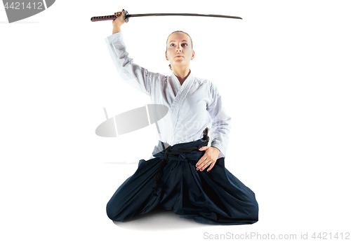 Image of Aikido master practices defense posture. Healthy lifestyle and sports concept. Woman in white kimono on white background.