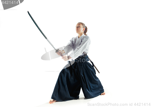 Image of Aikido master practices defense posture. Healthy lifestyle and sports concept. Woman in white kimono on white background.