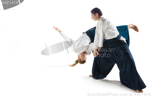 Image of Man and woman fighting at Aikido training in martial arts school