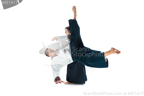 Image of Man and woman fighting at Aikido training in martial arts school