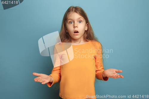 Image of The surprise. Teen girl on a blue background. Facial expressions and people emotions concept