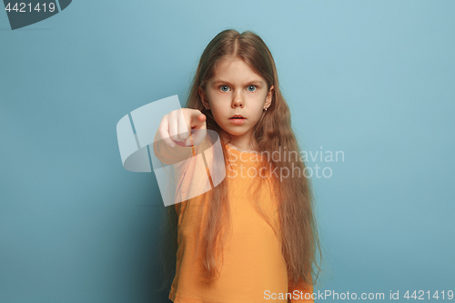 Image of The determination. Teen girl on a blue background. Facial expressions and people emotions concept