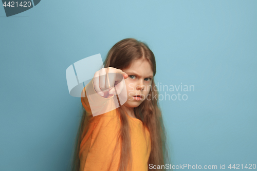 Image of The determination. Teen girl on a blue background. Facial expressions and people emotions concept