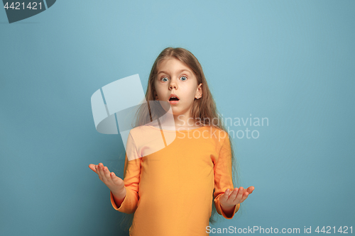 Image of The surprise. Teen girl on a blue background. Facial expressions and people emotions concept