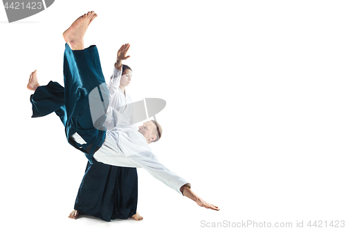 Image of Man and woman fighting at Aikido training in martial arts school