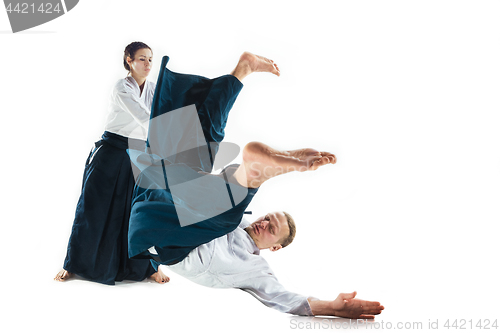 Image of Man and woman fighting at Aikido training in martial arts school