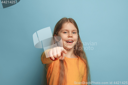 Image of The determination. Teen girl on a blue background. Facial expressions and people emotions concept