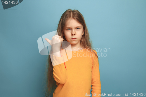 Image of The determination. Teen girl on a blue background. Facial expressions and people emotions concept