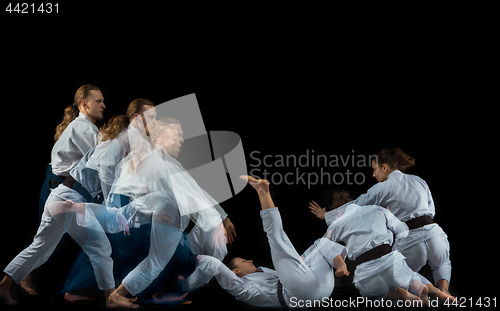 Image of Man and woman fighting at Aikido training in martial arts school