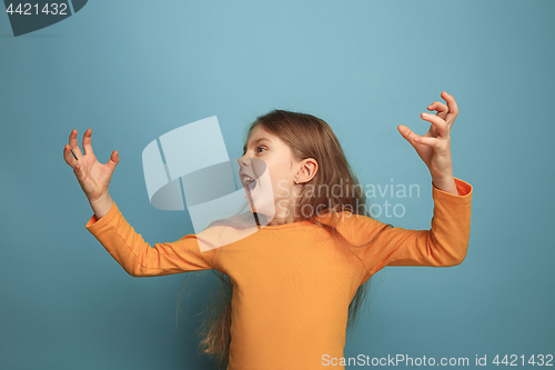 Image of The surprise. Teen girl on a blue background. Facial expressions and people emotions concept