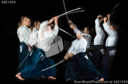 Image of Man and woman fighting at Aikido training in martial arts school