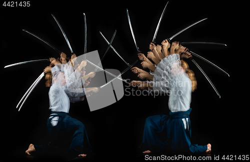 Image of Man and woman fighting at Aikido training in martial arts school