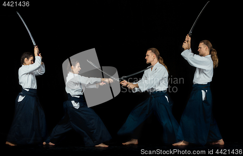 Image of Man and woman fighting at Aikido training in martial arts school