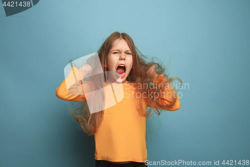 Image of The surprise. Teen girl on a blue background. Facial expressions and people emotions concept