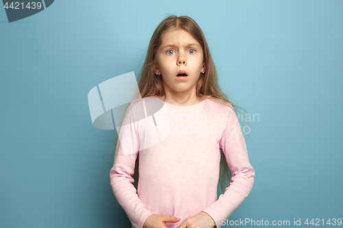 Image of The surprise. Teen girl on a blue background. Facial expressions and people emotions concept