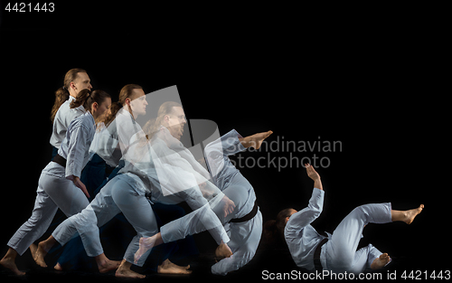 Image of Man and woman fighting at Aikido training in martial arts school