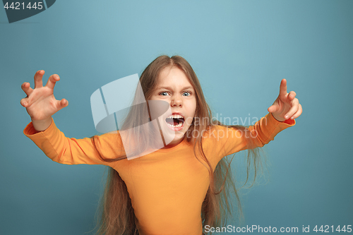 Image of The surprise. Teen girl on a blue background. Facial expressions and people emotions concept