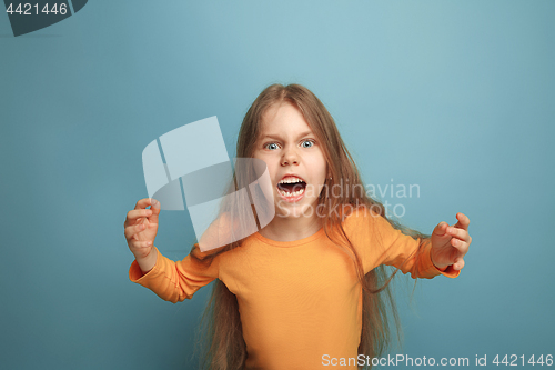 Image of The surprise. Teen girl on a blue background. Facial expressions and people emotions concept