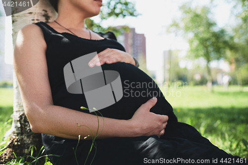 Image of Pregnant woman in black dress