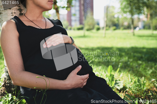 Image of Pregnant woman in black dress