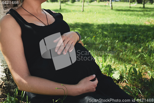 Image of Pregnant woman in black dress