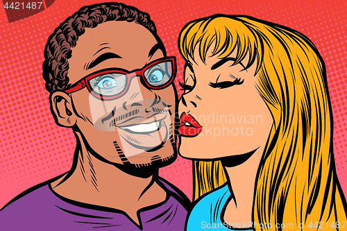 Image of woman kisses a man. multi-ethnic couple. joy smile