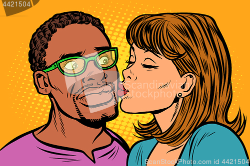 Image of woman kisses a man. multi-ethnic couple. embarrassment