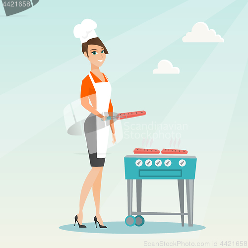 Image of Woman cooking steak on barbecue grill.