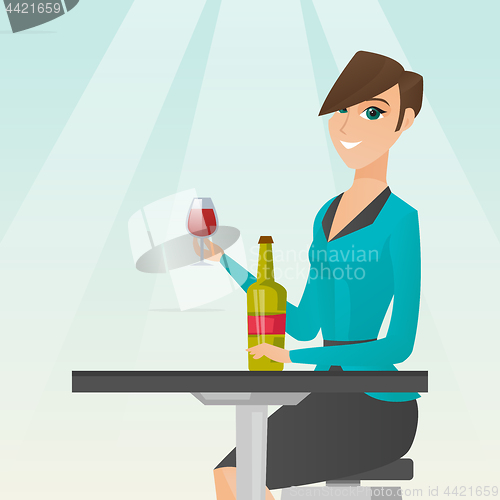 Image of Woman drinking wine in the restaurant.