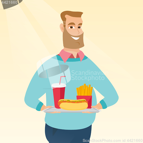 Image of Man holding tray full of fast food.