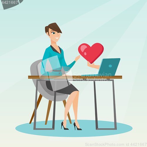 Image of Young woman using a laptop online dating.