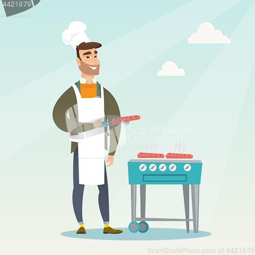 Image of Man cooking steak on barbecue grill.