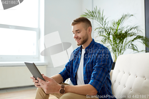 Image of happy smiling man with tablet pc at office