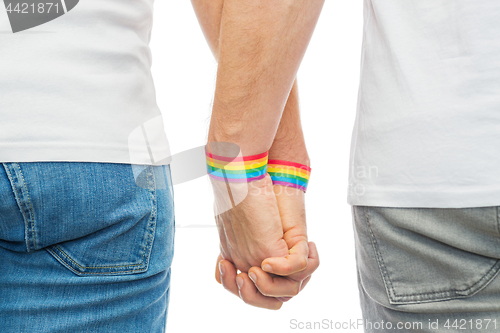 Image of male couple with gay pride rainbow wristbands