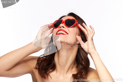 Image of woman with red lipstick and heart shaped shades