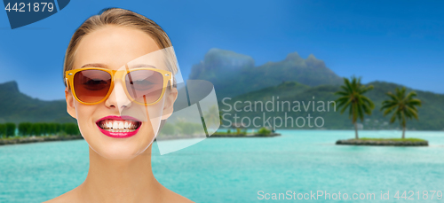 Image of woman in sunglasses over bora bora beach