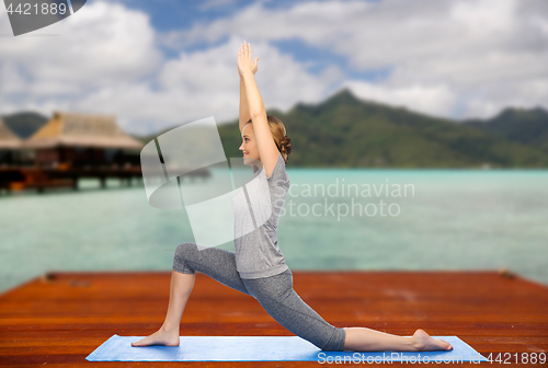 Image of happy woman making yoga in low lunge outdoors